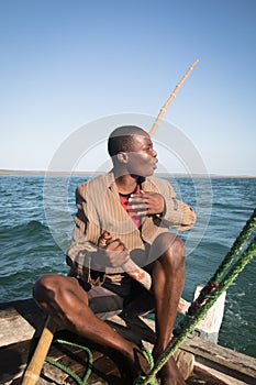 African man stearing a boat near Tofo